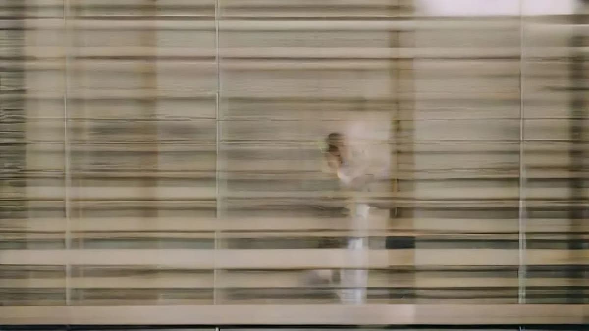 A professional working on a laptop in a modern office setting, representing the high-value human writer role at Anthropic.