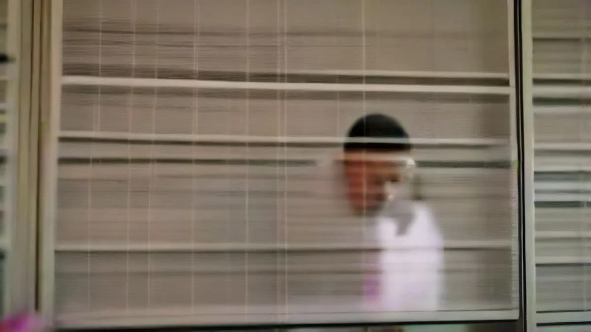 An election official reviewing voter registration documents at a desk in New Delhi