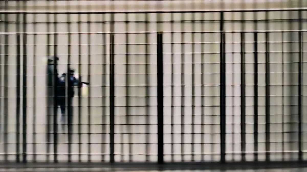 French police officers standing guard near a barricaded street in Paris during a security lockdown.