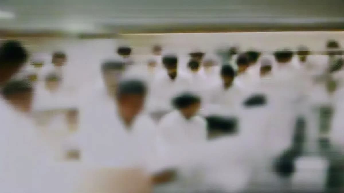Students in lab coats working in a modern biotechnology laboratory