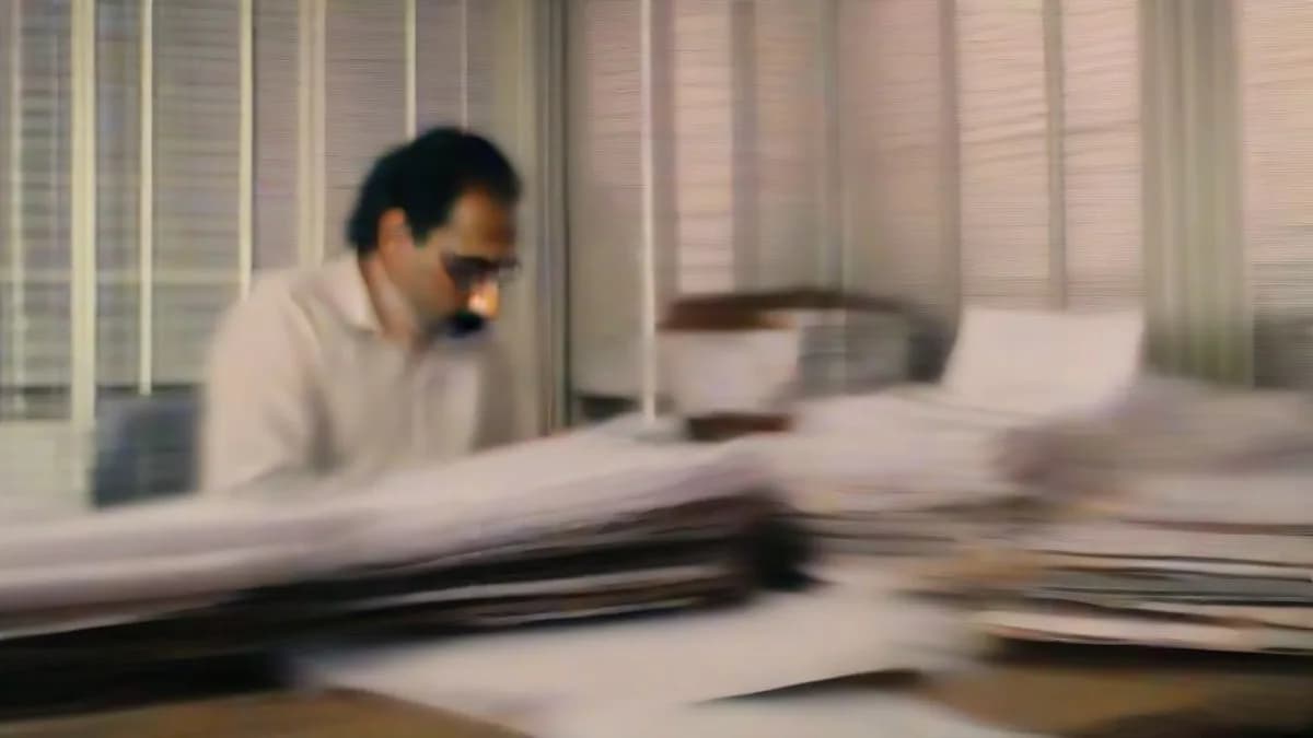 A businessman reviewing financial documents at an office desk