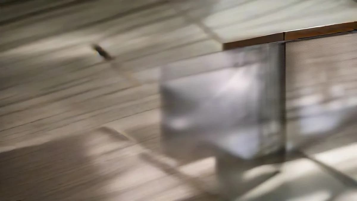 An empty glass display case inside a dimly lit historical museum gallery.